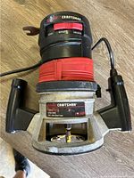 Top view of the Craftsman router showing control dial, handles, and power cord.