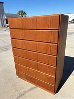 Front right angled view of six-drawer dresser showing overall design and condition.