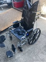 Full view of the Excel extra large wheelchair showing reclining backrest, footrests, and wheelie bars