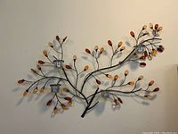 Full view of the metal branch wall candle holder showing overall size and design with four glass tealight holders and amber glass bead leaves.