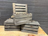 Front view of the two wooden planter crates stacked with lids and rope handles visible