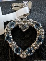 Close-up of the heart-shaped pendant showing the diamond setting and bail detail.