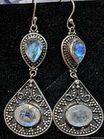 Front and side views of sterling silver earrings showing blue labradorite and moonstone in intricate beadwork