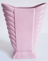 Front view of pink Art Deco style waterfall pottery vase with vertical ridge design and square base.