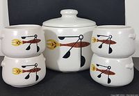 Full set view showing one bean pot with lid and four smaller serving bowls arranged around it, displaying the matching mid-century graphic design.