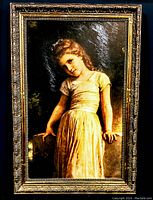 Full view of the canvas transfer painting showing a young girl in a yellow dress, framed in an ornate black and gold frame.