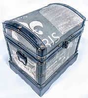 Angled view of the dome-top vintage jewelry box showcasing fabric with Paris print and brass studs on black leather-like trim.