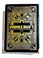 Front view of the black gift box with gold illustrated maze pattern and Minecraft symbols, showing the title.