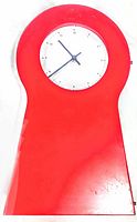 Front view of the vintage red metal wall mount clock showing the round white clock face with black numerals and hands.