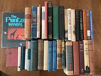 Photo showing a lineup of 27 vintage hardcover books of varying titles, colors, and sizes, including 'The Penton Manual' and other classic titles.