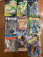 Photo showing all nine figures in their original packaging laid out on a wooden surface.