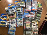 Overview photo of many Hot Wheels cars and multipacks laid out, showing variety and quantity