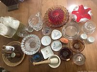 Overview photo of all items showing ashtrays, glassware, ceramic trinket dishes, mortar and pestle, egg holders, and Woodpecker Woodware pieces.