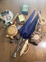 Lot overview showing all items including umbrellas, canteens, pestle, clock, thread box, Fred plate and small silver cups