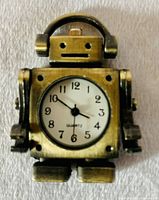Front view of brass robot pocket watch pendant showing watch face and upper body details.