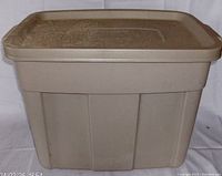 Front view of grey Rubbermaid Roughneck storage box with lid showing the full profile.