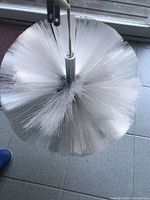 Top-down close-up view of the Ikea Kallt fibre optic ball light, showing the dense cluster of white optical fibers attached to a central cylindrical metal piece.