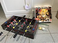 Tabletop Pro Kick foosball game with balls and Ramset LEGO Pyramid set in box.