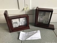 Pair of wooden bookends each with a 3-D photo frame displaying black and white photos, positioned to show front and side view along with instruction paper.