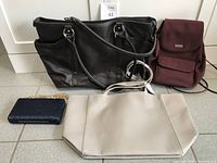 Overview of all four bags: black leather tote bag, burgundy backpack, beige shoulder handbag, blue evening clutch.