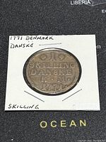 Obverse side of the 1771 Denmark 1 Skilling bronze coin showing denomination and date.