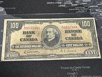 Front view of banknote showing full face design, portrait, serial number, bilingual text.