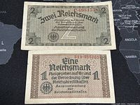 Front side of 2 Reichsmark and 1 Reichsmark German banknotes from the 1940s 3rd Reich period.