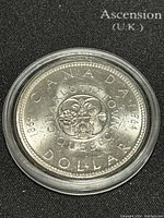 Front side of the coin showing the Charlotte Town Quebec design with 1864-1964 dates and CANADA DOLLAR text.