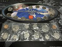 Photo of the 2000 Millennium Canada BU Coin Set with 14 coins displayed on a space-themed insert showing earth with 'Millennium Canada Millenaire 2000' text.