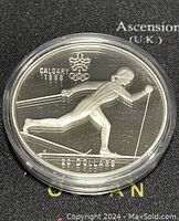 Obverse side of the silver coin featuring cross country skiing motif with Calgary 1988 and 20 dollars inscribed.