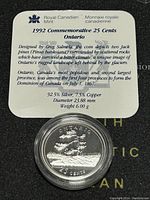 Photo shows the coin in protective plastic case with informational card describing the coin's design, composition, dimensions, weight, and historical significance.