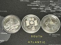 Three Canadian silver dollar coins displayed showing their reverse sides with detailed engravings and dates 2003, 2005, and 2010.