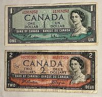 Front side of 1954 Canadian one and two dollar bills showing Queen Elizabeth II portrait with signatures and serial numbers.