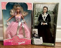 Both Barbie dolls in original packaging side by side showing the packaging condition and doll attire.