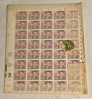 Full sheet of 50 Elvis Presley 29 cent stamps arranged in a 10x5 layout, with visible wear and discoloration around edges.