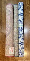 Rolled view of three indoor/outdoor carpets showing color and pattern of each.