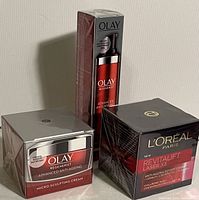 Image showing sealed Olay Regenerist Micro-Sculpting Cream jar and bottle alongside L'Oreal Revitalift Laser X3 Anti-Ageing Power Cream box.
