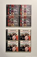 Top view of 6 Beatles CDs in cases - 3 White Album, 3 Revolver