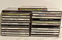 Two stacks of Beatles and solo Beatles CDs showing titles and labels on the spine