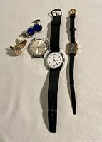All watches and cuff links laid out on fabric background, showing vintage Timex, Cardinal watches and both pairs of cuff links.