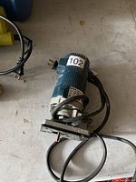 Full view of the Bosch 1608 router showing the base, power cord, and main body.