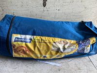 Blue carrying bag with Broadstone branding and product label showing product details and image of the screen house tent.