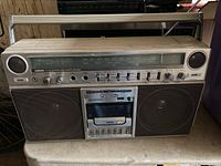 Front view of vintage Panasonic radio cassette deck boombox showing speakers, radio tuner display, controls, and cassette player.