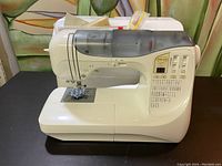 Front angle view of sewing machine on table