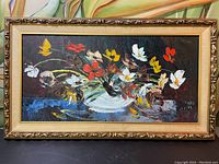 Wide shot of framed oil painting, floral still life.