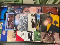Photo showing most of the assorted LP records laid out, front covers visible including Rod Stewart, Linda Ronstadt, Cliff Richard, Minnie Riperton, Smokey Robinson and the Miracles, REO Speedwagon, Peaches & Herb, Village People and others.