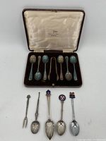Photo of the set of seven cased silverplate teaspoons arranged in the velvet-lined case, satin lid marked Walters J.A. Hall Sheffield.