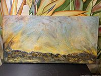 Full view of abstract modern acrylic painting on canvas showing textured brown, yellow, and gold colors.