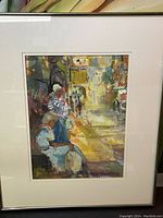 Framed watercolour painting of a street scene with figures, focusing on the seated individuals in foreground and alleyway light effects.