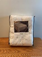 Photo of Bates Martha Washington's Choice bedspread packed in a transparent pouch showing the label with bedspread image and brand.